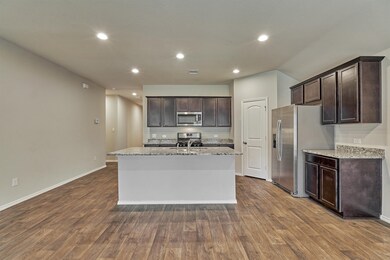 Island kitchen with Whirlpool appliances, walk in pantry, breakfast bar and maple espresso cabinets