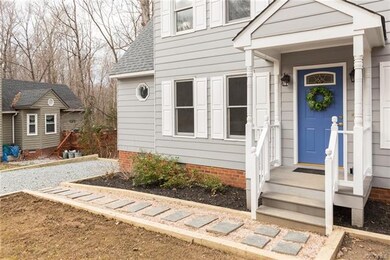 New walkway! Cute covered porch and steps boasts n