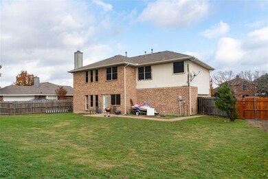 Back of house featuring a lawn and a patio
