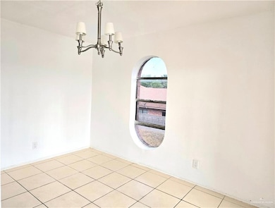 Kitchen with light tile patterned floors, stainless steel microwave, a sink, tasteful backsplash, and electric range