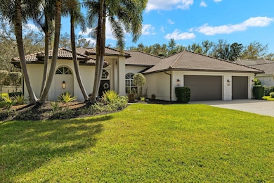 Mediterranean / spanish-style home with a front lawn, stucco siding, a tile roof, driveway, and an attached garage