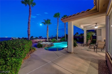Pool at twilight with a ceiling fan, a patio, and