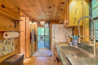 View of galley kitchen to back porch and bathroom