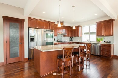 Chef's kitchen with slab counter tops, double oven, soft close cabinets and drawers, stainless steel appliances and walk in pantry.
