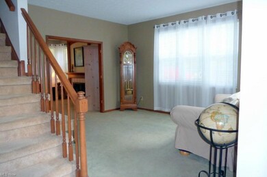 The living room offers a large window and neutral 
