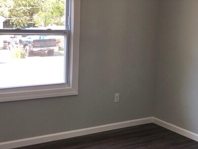 Spare room featuring dark hardwood / wood-style fl