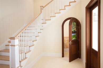 Grand foyer with a powder room just off the main e