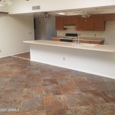 kitchen has a large breakfast bar open t