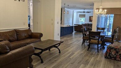 living room view to kitchen and family room