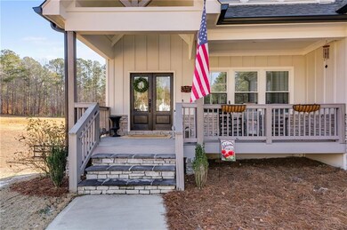 View of exterior entry with french doors and a por