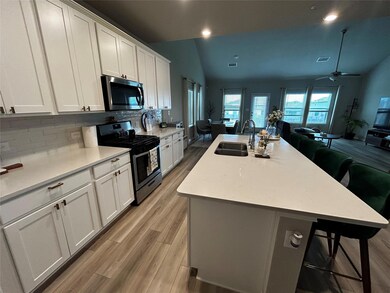Kitchen featuring stainless steel appliances, ope