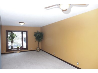 Living room with bay window and new carpeting.