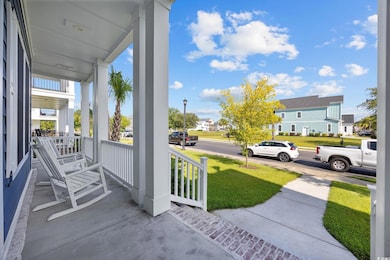 Covered porch featuring a residential view and a yard
