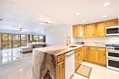 Waterfall granite in the kitchen opened up to the dining and living rooms for a large spacious living area