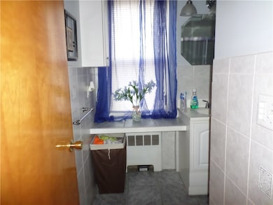 2nd floor bathroom- tile floor, tile walls & tub/s