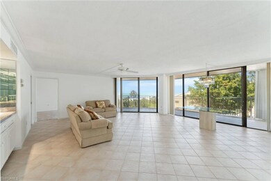 Living room with crown molding, light tile pattern