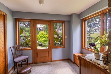 Entryway featuring light colored carpet and baseboards