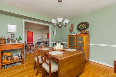 Beautiful hardwood floors and chair rail in dining  room.