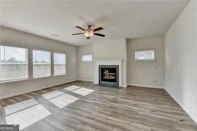 Unfurnished living room with a fireplace with flus