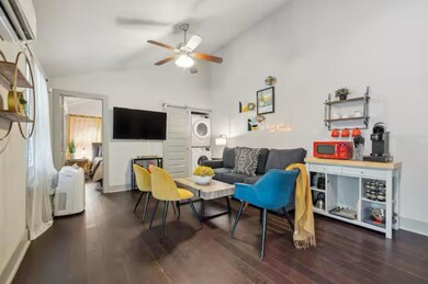 Living room with stacked washer / dryer, lofted c