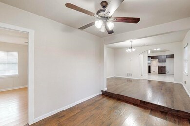 Unfurnished living room featuring ceiling fan with