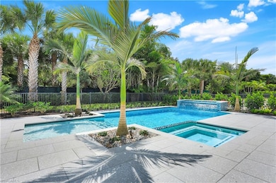 View of swimming pool with a patio area, a fenced backyard, and a pool with connected hot tub