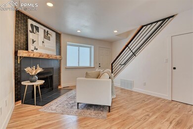 Sitting room featuring a fireplace and wood-type f