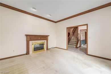 Unfurnished living room featuring light tile floors, ornamental molding, and a tile fireplace