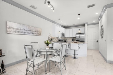 Dining space with light marble finish flooring and recessed lighting