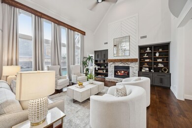 Living room with a fireplace, high vaulted ceiling