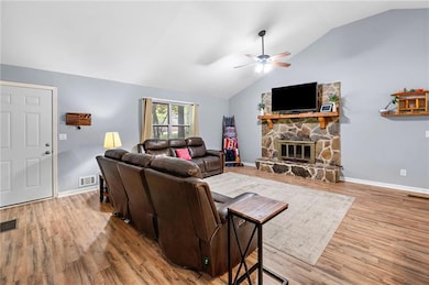 Living room featuring a ceiling fan, lofted ceilin