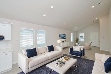 The soaring vaulted ceilings and recessed lighting create an airy and expansive atmosphere.