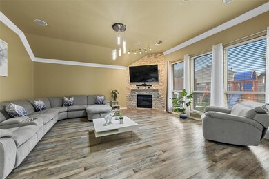 Living room featuring a notable chandelier, a ston