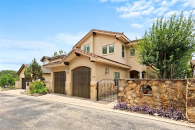 View of front of property with a tile roof, stucc