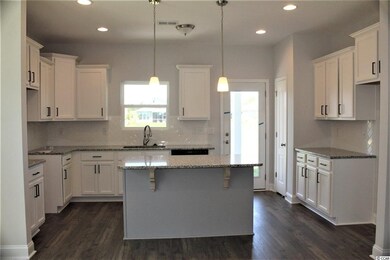 Large Island with granite counter tops. White cabi