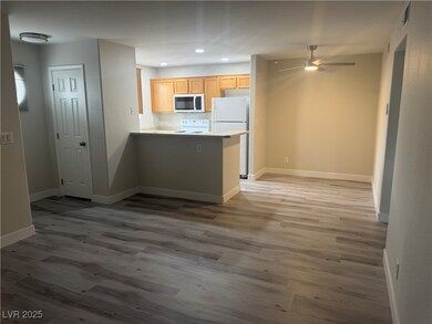 Kitchen featuring white appliances, a peninsula, b