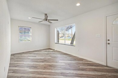 Living room with new flooring, ceiling fan and lot