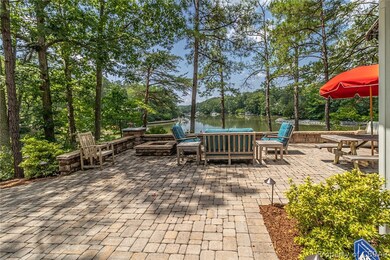 Paver patio with wood-burning fire pit on elevated