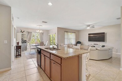 The open layout connects the kitchen, living, and dining areas, offering a seamless flow for entertaining and daily life.