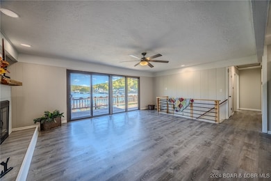 View of the Lake Front Living Room & Staircase to