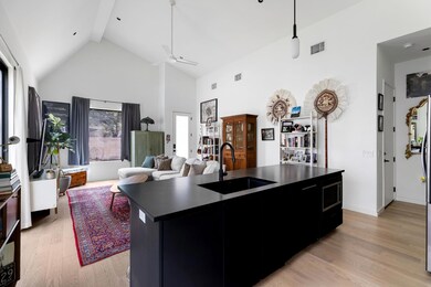 Kitchen featuring dark countertops, high vaulted 