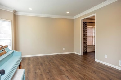 Unfurnished room featuring ornamental molding, dark wood-style flooring, and recessed lighting