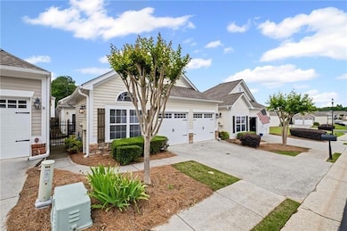 View of front of home with driveway and an attached garage