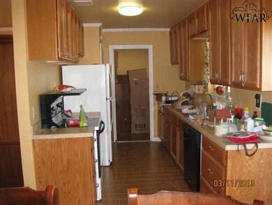 New counters, cabinets, tile lead into the utility