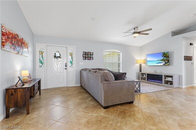 Living room featuring tile flooring, ceiling fan,