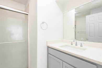 Bathroom featuring vanity and a stall shower