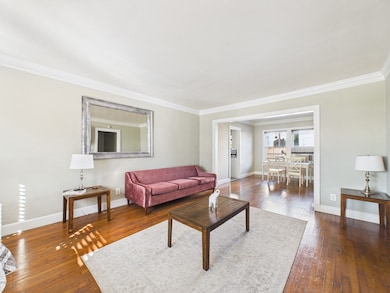 Living & Dining Areas with Crown Molding and Original Hardwood Floors