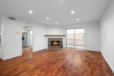 Unfurnished living room featuring visible vents, b