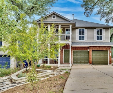 In the daylight, the home’s charm shines through its clean lines, front porch, and leafy surroundings. You’ll love how the soft gray tones pair with the classic brick — it’s the kind of exterior that never tries too hard yet always stands out.