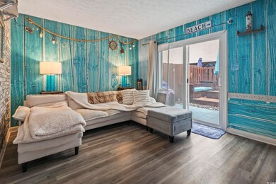 Living room featuring a textured ceiling, an invit